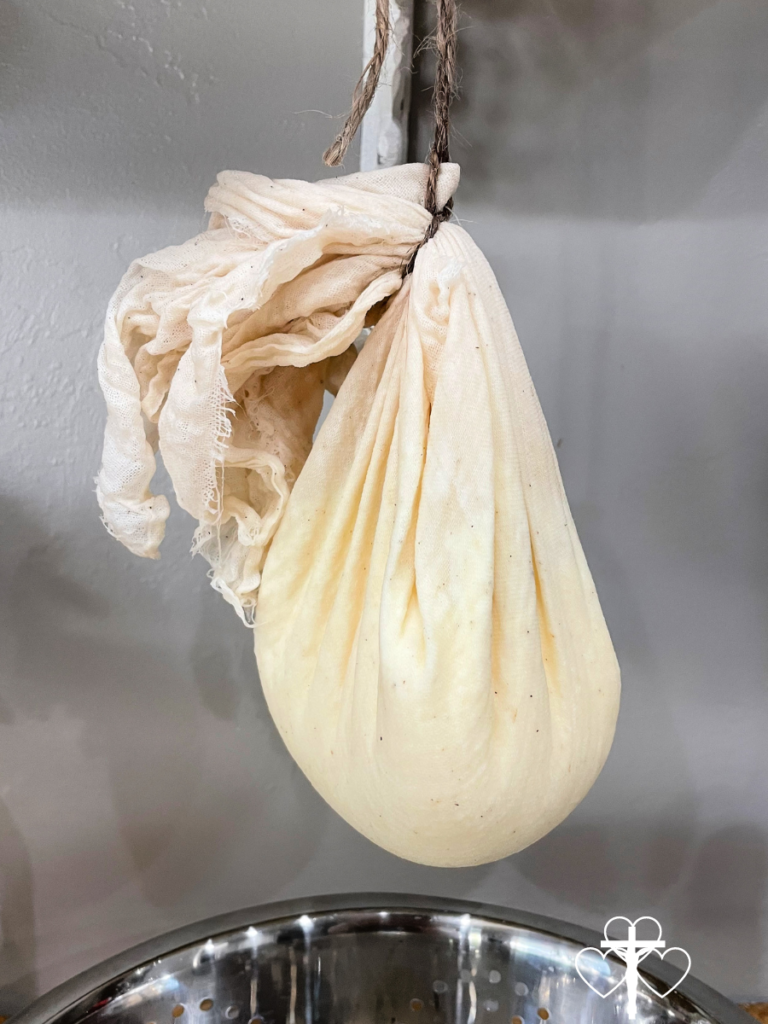 Yogurt cheese hanging in a cheesecloth to strain.