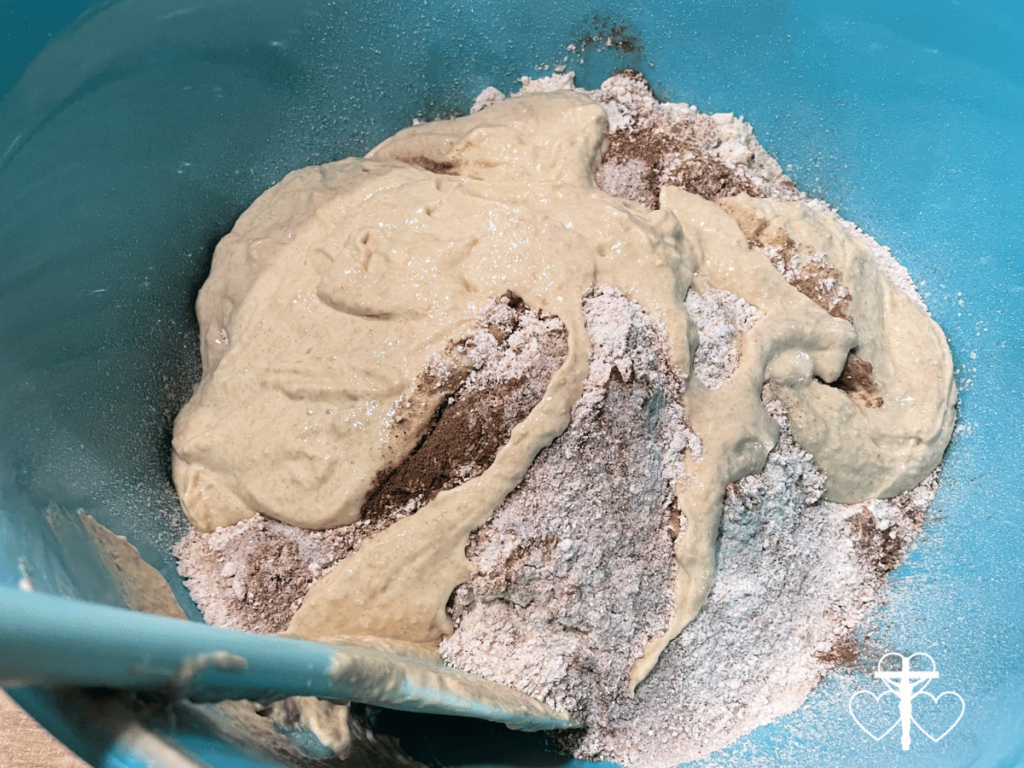 Picture of loose dough ingredients in a bowl with a spatula.